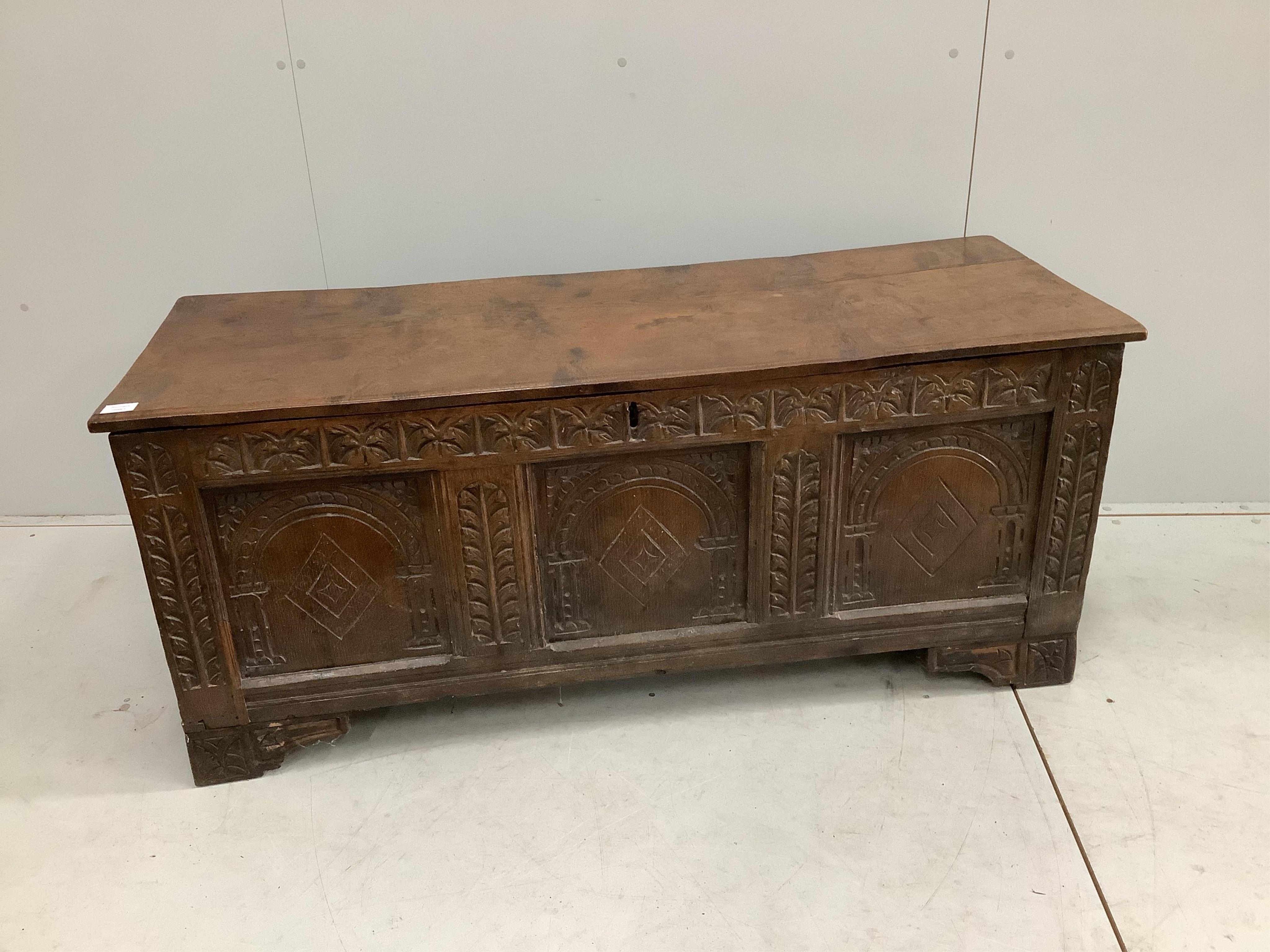 An 18th century carved oak coffer, width 140cm, depth 53cm, height 59cm